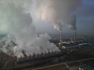 Thermal power plant. Active smoke from pipes and cooling towers. The view from the drone.