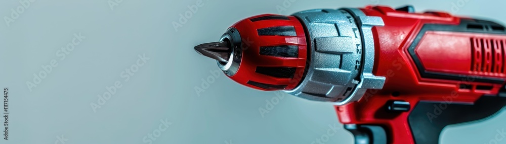 Poster a close-up of a red power drill highlighting its metallic features and design, ideal for constructio