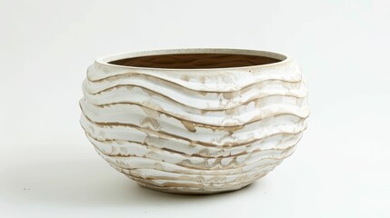 Fototapeta premium A textured, white ceramic bowl with wavy patterns, showcasing a minimalist design suitable for decor or plant display.
