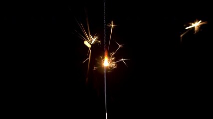 Experience the mesmerizing glow of a bengal light igniting in the dark, spreading sparks and bright colors for all to enjoy during festive celebrations