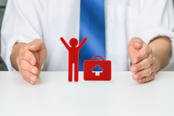 Healthcare, medical insurance, and patient advocacy : A businessman protects the red figure and red...
