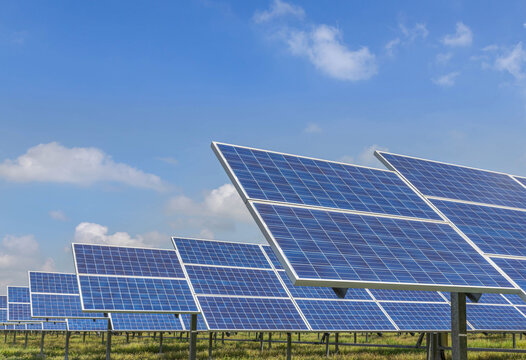    Close up rows array of Solar panels or solar cells or photovoltaics in solar power station on blue sky , clean energy power sustainable energy environmentally friendly