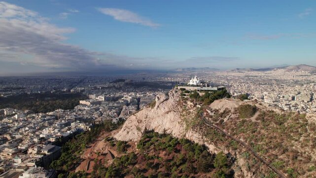 Aerial panorama of Athens, Greece, Lycabettus Hill Park in foreground, 4K