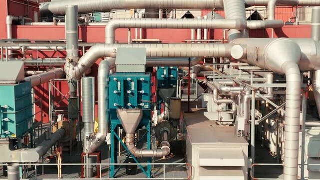 Close-up of HVAC rooftop system with pipes and ducts, focus on energy-efficient industrial design, tracking right