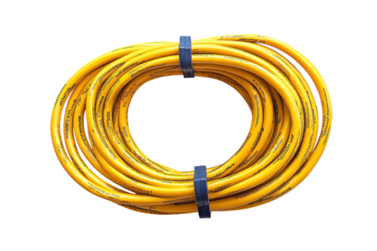 Coiled yellow electrical extension cord ready for use at a construction site or outdoor event