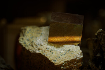 A cube of pyrite in a stone.
