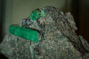 Green emerald on stone in collection.
