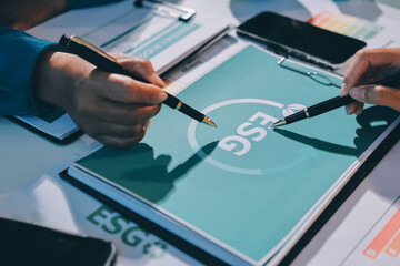 ESG environmental social governance display on laptop on eco-friendly company meeting with business...
