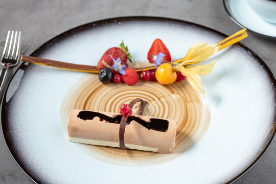 Stylish modern presentation of fruit chocolate mousse or semi-frozen parfait