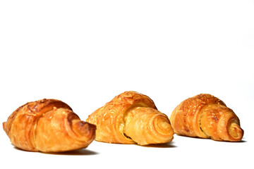 Left view of three Freshly baked mini croissants isolated on white background. Fresh croissant bread isolated.