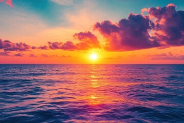 Fototapeta premium A vibrant sunset over the ocean, reflecting colorful hues on the water.