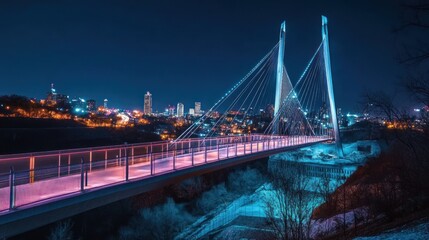 Illuminated cable-stayed bridge at night over city.