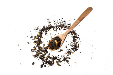Top view of dried tea leaves on wooden spoon. isolated on white background. Scattered dried tea...