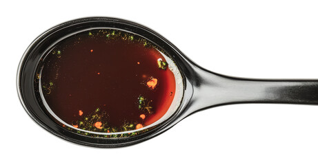 Dark sauce in a ceramic spoon on white background, cut out - stock png.