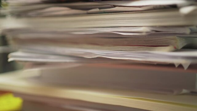 Pile of disorganized paper work. Overworked concept.