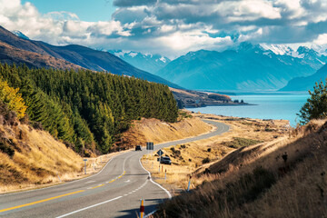 Scenic Peters lookout with winding road and Mount Cook and Lake Pukaki on sunny day in autumn at New Zealand