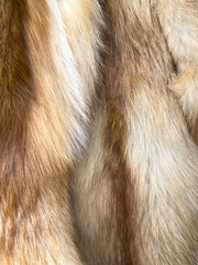 A close up of a fur coat with a brown and white color