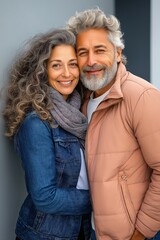 A pair of elderly lovers. A man with silver hair and a woman, embracing, facing the camera. a happy older couple in their sixties
