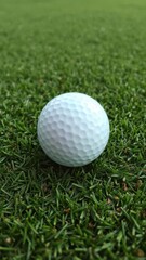 Fototapeta premium Close-up of golf ball on green grass surface with small dimples, outdoor, golf ball