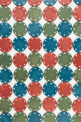 Top view of poker chips on white background. Lot of gambling chips. Board game, playing cards, poker, casino. Copy space, flat lay.