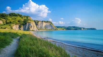 Obraz premium Coastal landscape with rocky cliffs and serene blue sea on a sunny day Discover National Parks Fortnight