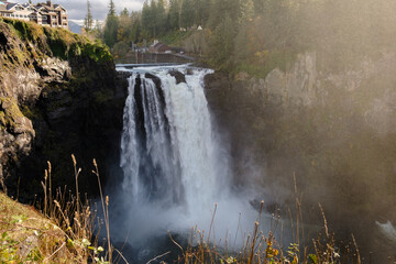 Snoqualmie Falls with lush greenery and mist in Washington State © JulPhoto