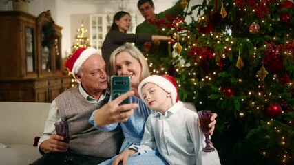 Family photo by mobile phone, grandparents and child boy taking selfie in Xmas. Happy new year and merry Christmas, cheerful people celebrating holidays with family, take pictures by modern smartphone