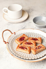 French style puffs, butter cookies biscuits with strawberry jam, in large round tins containing 5 types of puffs with the perfect blend of soft butter and sweet flavors.