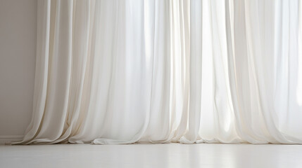 Soft white curtains flowing gently onto a sunlit floor, creating a serene and airy atmosphere.