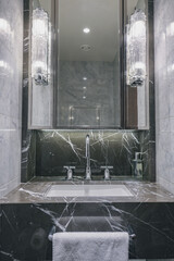 Super deluxe black and white marble bathroom of suite stateroom cabin onboard luxury ocean liner...