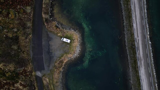 Aerial drone topdown view of van sitting by side of a road in Lofoten, Norway