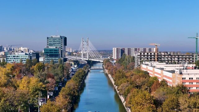 Flying Over Dambovita River in Regie Neighborhood with Ciurel Bridge Behind, Autumn, Bucharest, Romania