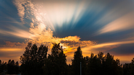 Sunset with dramatic clouds creating strong rays of light