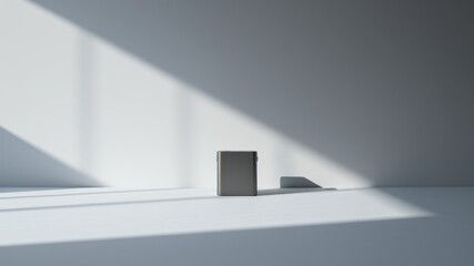 Minimalist product photography with a single rectangular object in soft natural light, casting a delicate shadow on a white surface.
