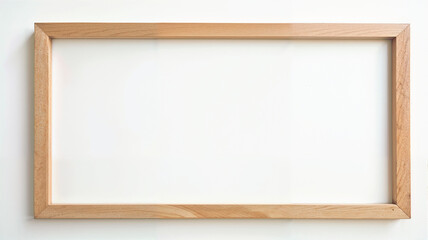 Fototapeta premium Wooden frame hanging on a wall, ready for artwork or photographs in a minimalist setting