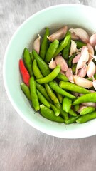 Chili and garlic in blue bowls on a dining table.