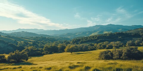 Fototapeta premium Peaceful landscape with rolling hills and a clear blue sky. The vibrant green grass contrasts beautifully with the gentle slopes. Ideal for nature lovers and outdoor enthusiasts. AI