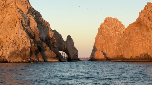 Back view the arch of Cabo San Lucas a distinctive granitic rock formation during sunset at the southern tip Cabo San Lucas, Baja California Sur,  Mexico.