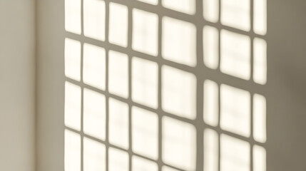 Soft shadows cast by a grid pattern on a light beige wall, creating a tranquil and minimalist atmosphere in the room.