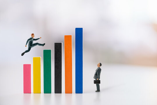"Leaping over barriers to achieve growth." The colorful blocks represent milestones or hurdles or problems, while the figure jumping signifies ambition, effort, and determination to reach new heights. - Powered by Adobe