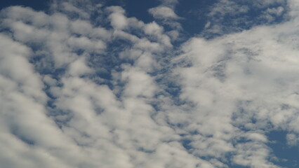 the clouds in the blue sky were lumpy