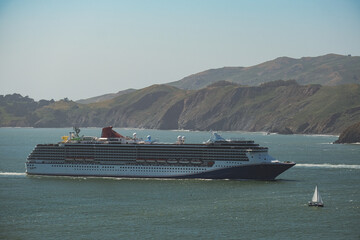 Modern family cruiseship cruise ship liner Miracle arrival in to San Francisco port with Bridge on...