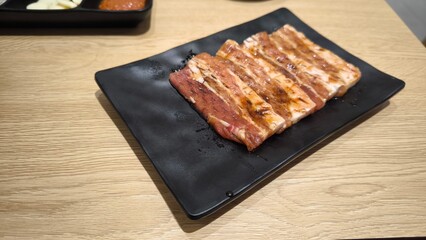 Korean style grilled beef on a black plate