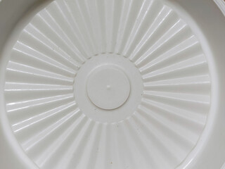a white patterned plastic plate