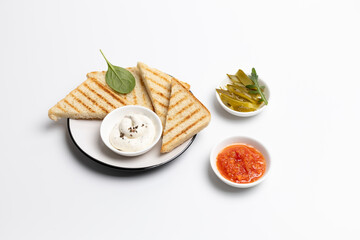 Homemade grilled toasts for breakfast with sauce on the white plate.