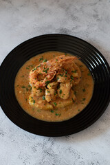 black dish with a fish recipe with shrimp. Food for celebration