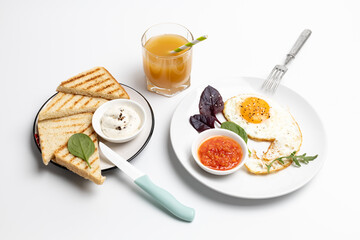 Fried egg on the plate and toasts with cheese sauce.