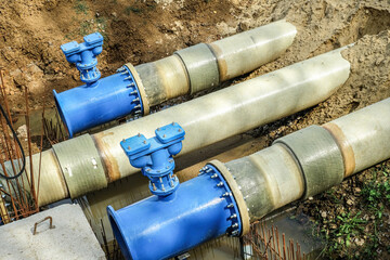 New fiber glass water pipeline in trench. Replacement of old rusty tubes by new one