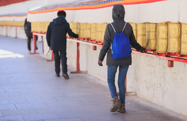 One Tibetan lady Spin the Tibetan Prayer Wheels in Potala place,Lhasa,China