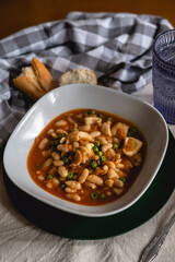 white bean soup casserole with cuttlefish. traditional dish for winter and cold days.